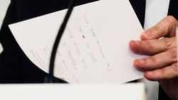 Secretary of State Marco Rubio writes a note before handing it to President Donald Trump during a roundtable meeting on antifa in the State Dining Room at the White House, Wednesday, Oct. 8, 2025, in Washington. (AP Photo/Evan Vucci)