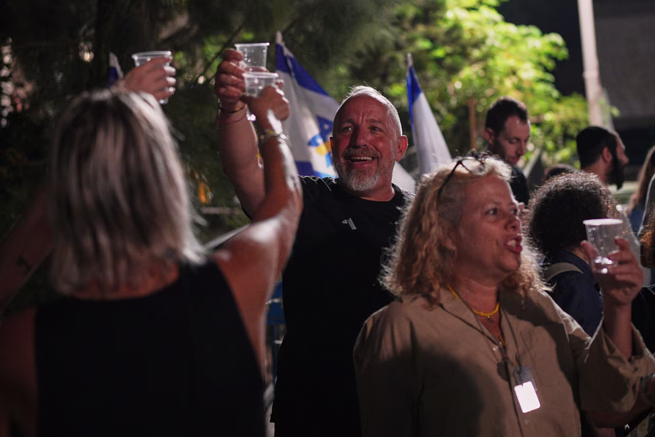 Relatives and supporters of Israeli hostages held by Hamas in the Gaza Strip celebrate after the announcement that Israel and Hamas have agreed to the first phase of a ceasefire, as they gather at a plaza known as the hostages square in Tel Aviv on Thursday,