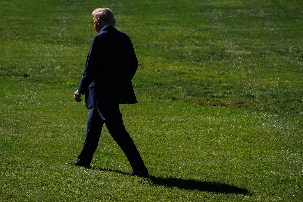 President Donald Trump walks across the South Lawn of the White House on Friday.