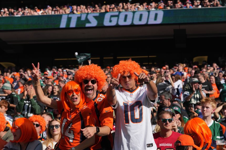 Broncos fans celebrate during the first half of Denver's game against the Jets in London.