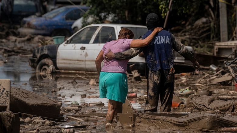 A Marine helps a woman cross a flooded street in Poza Rica in Veracruz state, Mexico, on Sunday, October 12.