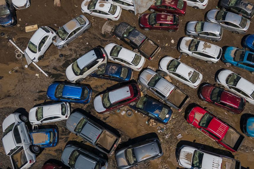 Damaged vehicles sit in mud after flooding in Poza Rica in Veracruz state, Mexico, on Sunday, October 12.