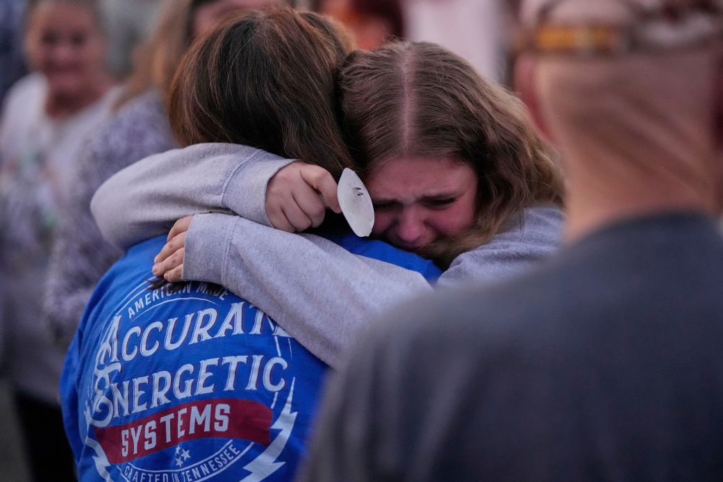 People console each other at a candlelight vigil for the victims of a blast at Accurate Energetic Systems, in Waverly, Tennessee, on Sunday.