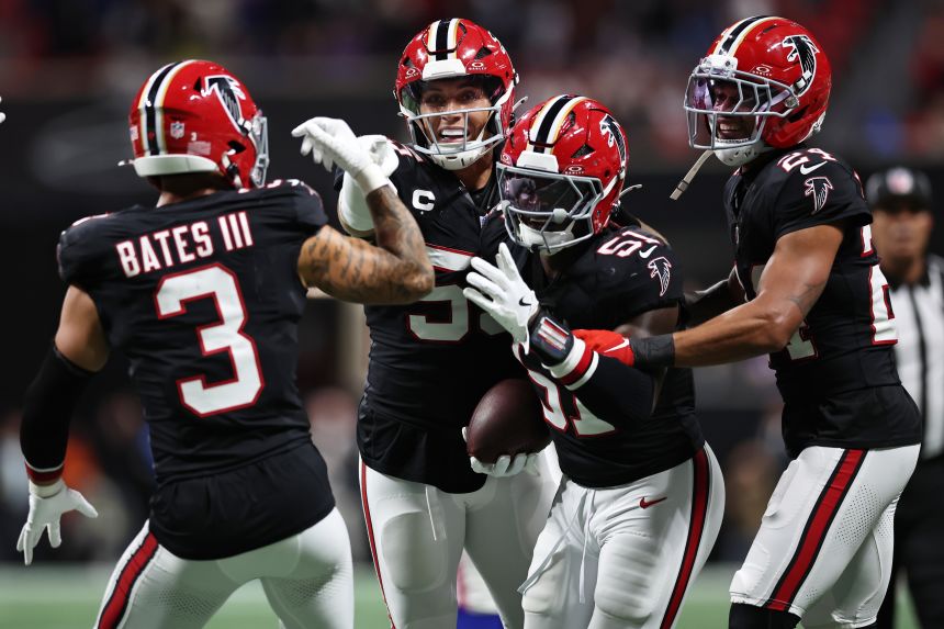Falcons players celebrate an interception against the Bills.