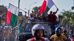 Protesters dance on top of a car during a protest calling for President Andry Rajoelina to step down in Antananarivo, Madagascar, Tuesday, Oct. 14, 2025.