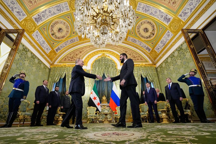 Russian President Vladimir Putin and Syria's interim president Ahmad al-Sharaa shake hands during a meeting at the Grand Kremlin Palace in Moscow, Russia, on October 15.