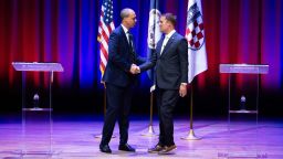 Democrat Jay Jones, left, and Republican incumbent Jason Miyares shake hands at the start of the Virginia attorney general debate in Richmond, Va., Thursday, Oct. 16, 2025. (Mike Kropf/Richmond Times-Dispatch via AP, Pool)