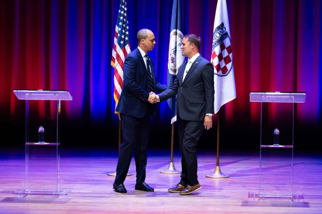 Democrat Jay Jones, left, and Republican incumbent Jason Miyares shake hands at the start of the Virginia attorney general debate in Richmond, Virginia, on Thursday.