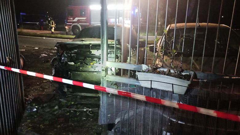 This image released by investigative journalist Sigfrido Ranucci shows his destroyed car, left, outside his home.