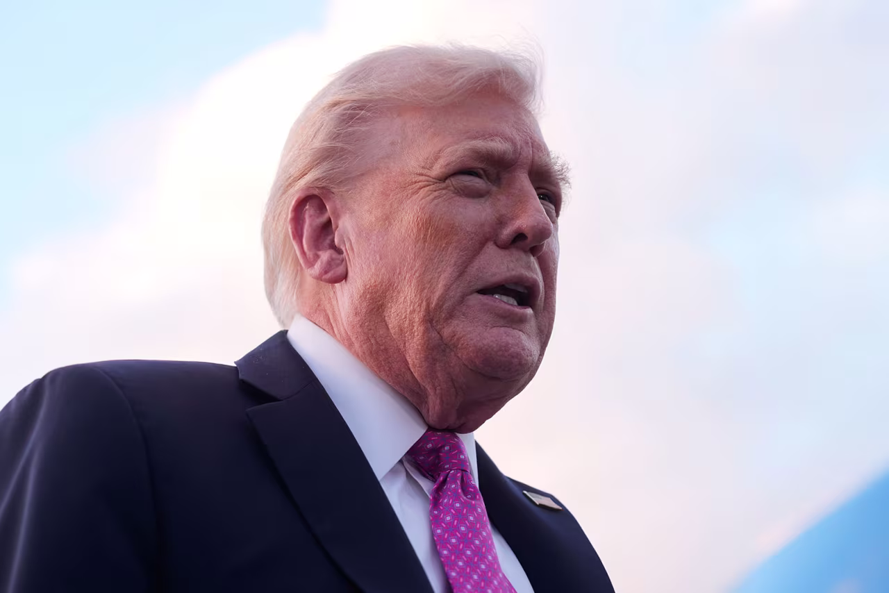 President Donald Trump speaks to reporters after arriving on Air Force One, Friday, at Palm Beach International Airport in West Palm Beach, Florida.