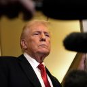 President Donald Trump speaks to reporters aboard Air Force One, Sunday, Oct. 19, 2025, en route to Joint Base Andrews, Md., as he returns from a trip to Florida. (AP Photo/Mark Schiefelbein)