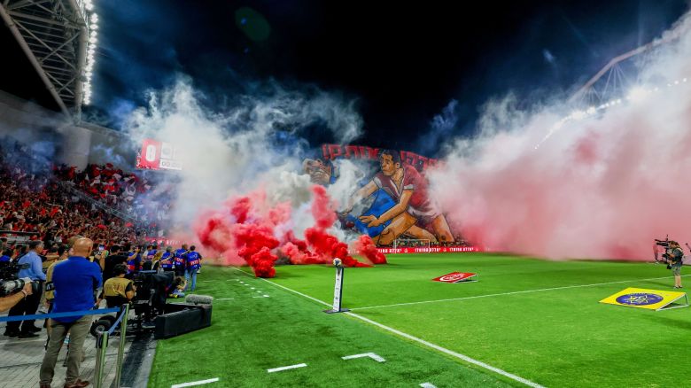 Smoke from flares thrown by fans fills the pitch before the soccer derby between Maccabi Tel Aviv and Hapoel Tel Aviv was called off Sunday.