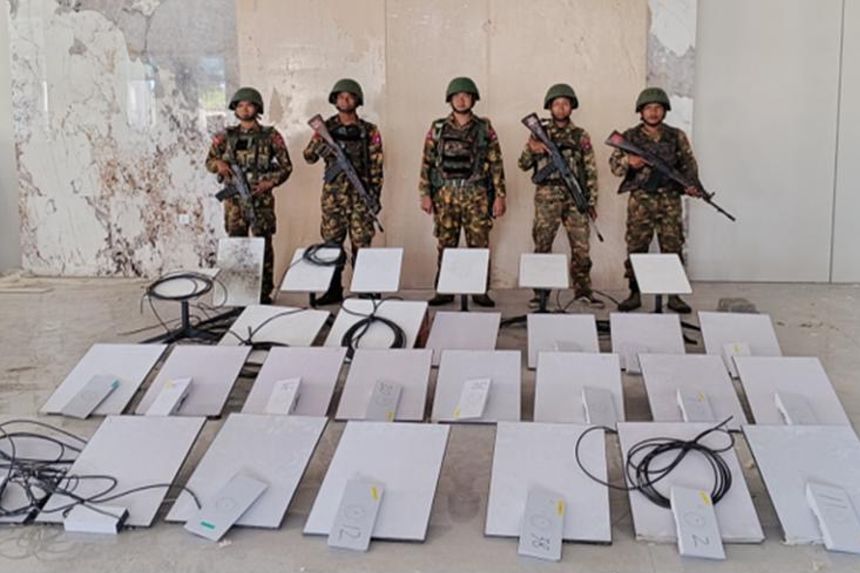 In this image provided by the Myanmar military on October 19, 2025, soldiers stand next to a Starlink machine during a raid on KK Park in Myawaddy township, Kayin state, Myanmar.