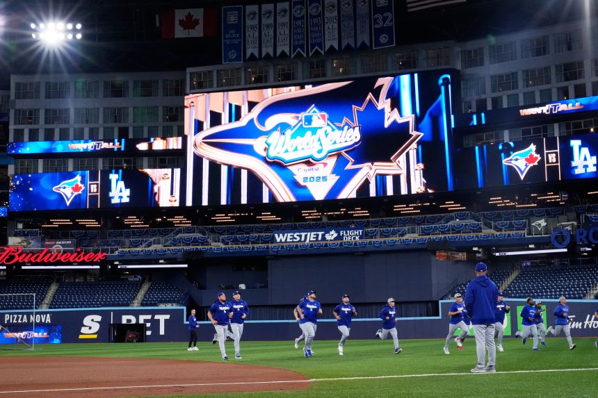 Members of the Dodgers warm up in Toronto a day ahead of the World Series.