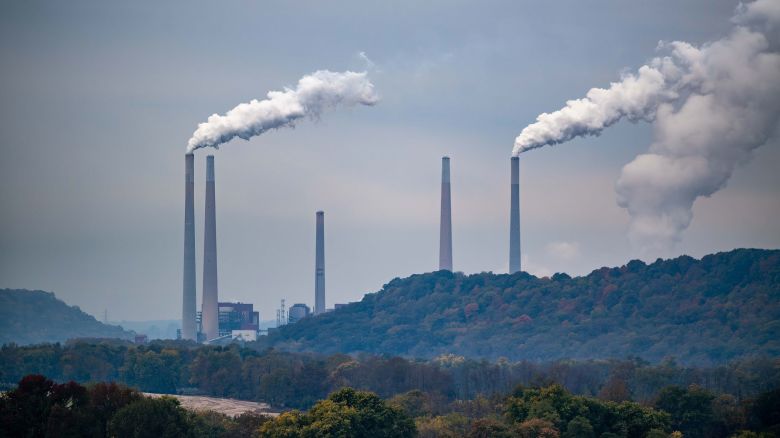 Pollution and steam rise from the stacks of the Miami Fort Power Station, which is situated along the Ohio River near Cincinnati, Ohio, on October 25. (Photo by Jason Whitman/NurPhoto via AP)