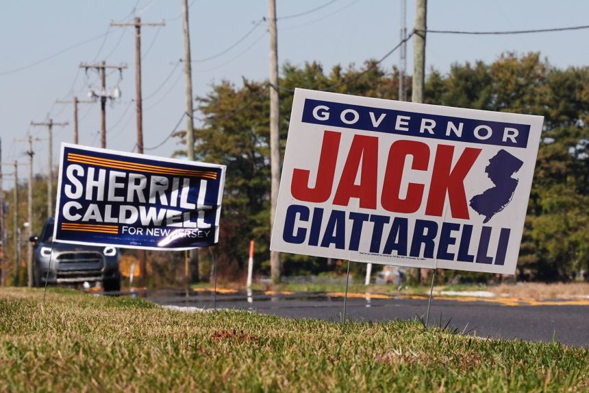 Campaign signs supporting New Jersey gubernatorial candidates Democratic Mikie Sherrill and Republican Jack Ciattarelli are posted along a roadside in Mount Laurel on October 27, 2025.