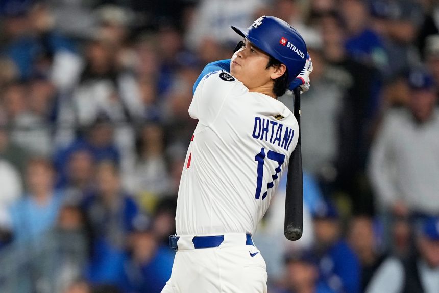 Los Angeles Dodgers' Shohei Ohtani watches his home run against the Toronto Blue Jays during the seventh inning in Game 3 of the World Series on Monday.