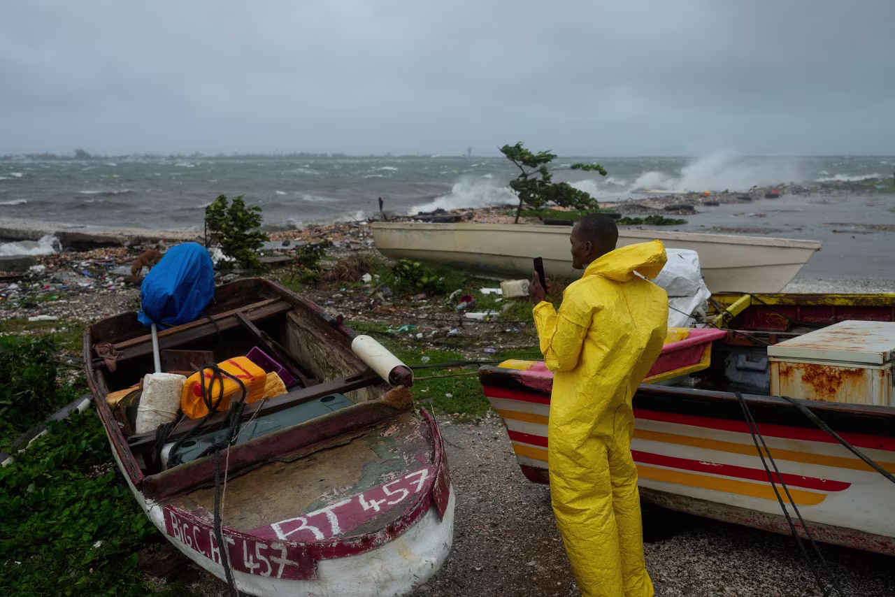 A man watches waves crash along the coastline in Kingston, Jamaica, on Tuesday morning.
