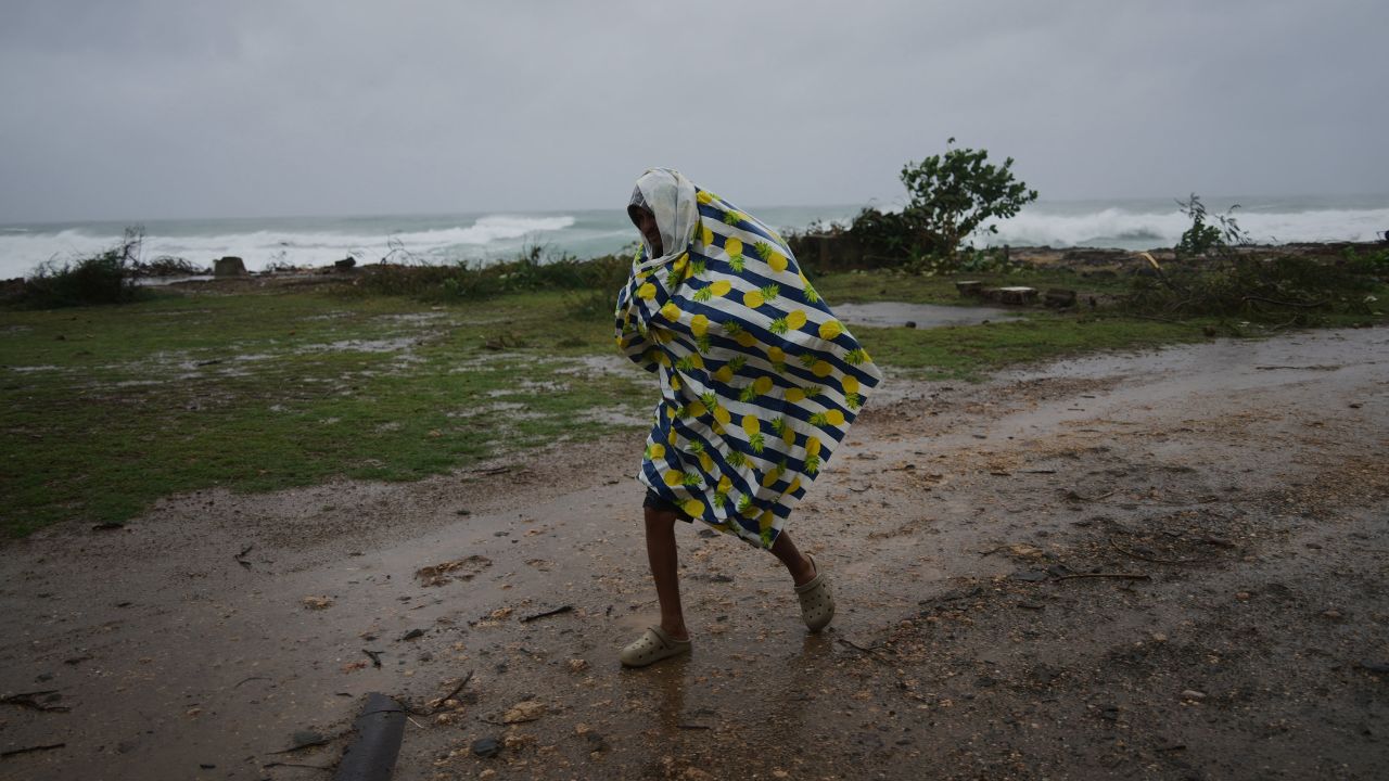 A man walks in the rain before the arrival of Hurricane Melissa in Canizo, a village in Santiago de Cuba, on October 28.