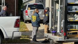 FBI agents stand outside a home in a Dearborn, Michigan, neighborhood Friday.