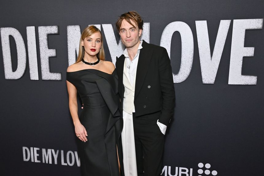 Jennifer Lawrence, left, and Robert Pattinson attend the premiere of 