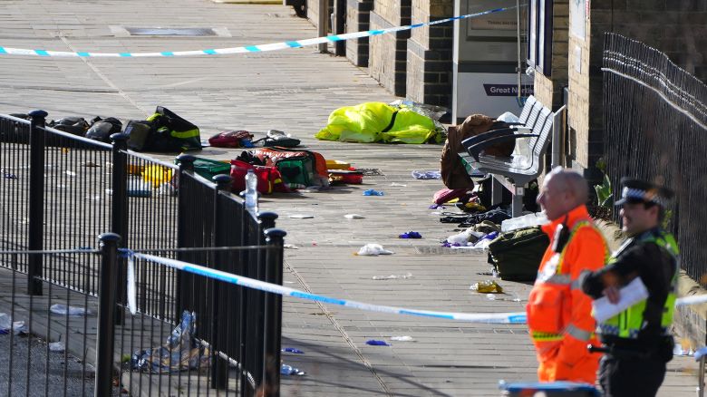 Belongings of escaping passengers are seen on the ground at the entrance to the train station after a mass stabbing on a London-bound train in Huntingdon, England, Sunday, Nov. 2, 2025.
