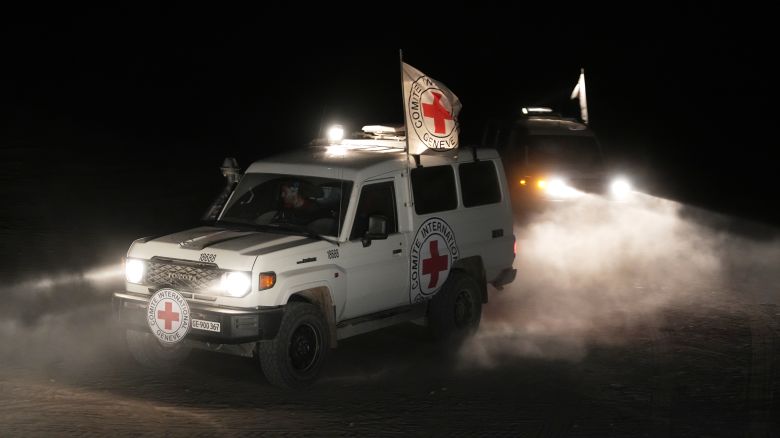 Red Cross vehicles carrying the bodies of three people believed to be deceased hostages handed over by Hamas make their way toward the border crossing with Israel, to be transferred to Israeli authorities, in Deir al-Balah, central Gaza Strip, Sunday, Nov. 2, 2025.