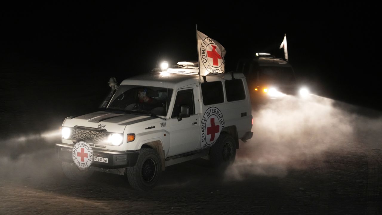 Red Cross vehicles carrying the bodies of three people believed to be deceased hostages handed over by Hamas make their way toward the border crossing with Israel, to be transferred to Israeli authorities, in Deir al-Balah, central Gaza Strip, Sunday, Nov. 2, 2025.