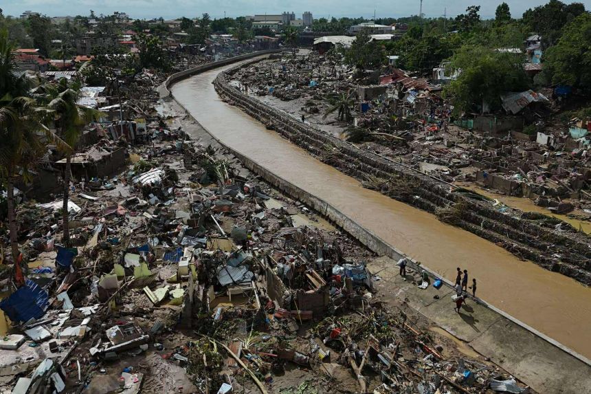 Residents return to what remains of their homes after Typhoon Kalmaegi devastated communities along the Mananga River in Talisay City, Cebu province, central Philippines onn November 5, 2025.