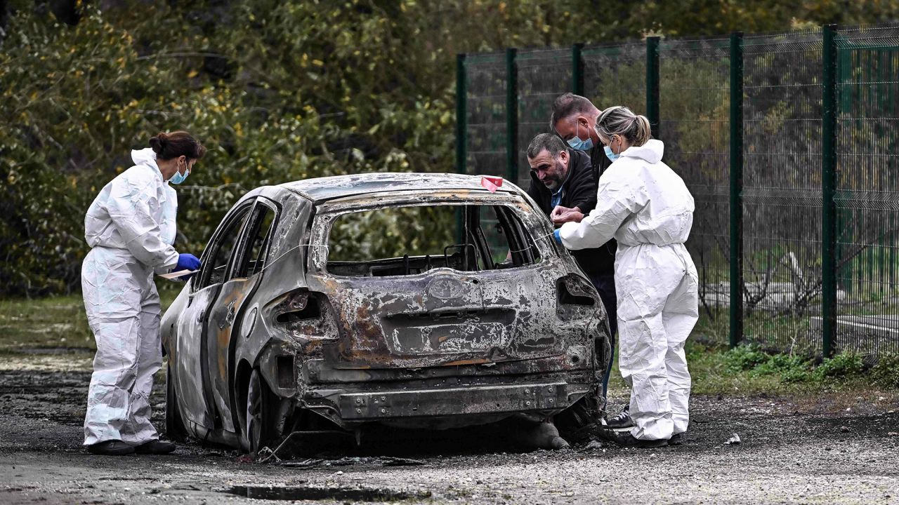 French police inspect the site where a burnt car was found in Saint Pierre d'Oleron following an incident where a car rammed into pedestrians and cyclists on Thursday, November 5.
