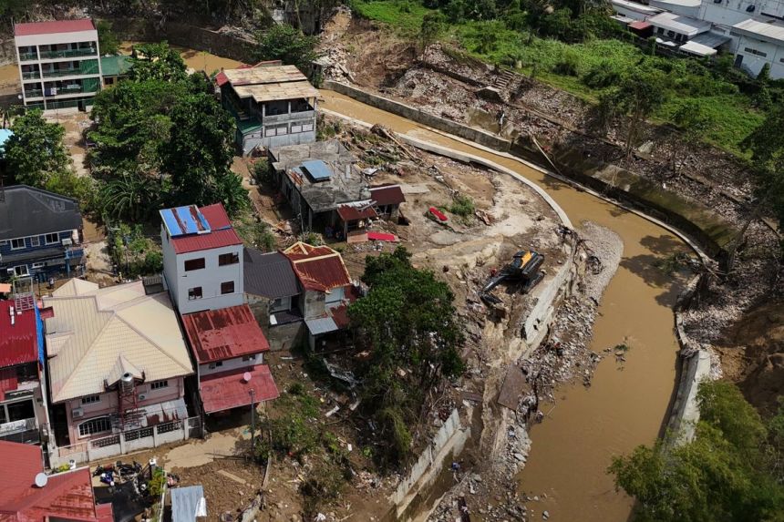Damaged houses along a river in Bacayan, Cebu province, central Philippines on November 7, 2025 after Typhoon Kalmaegi.