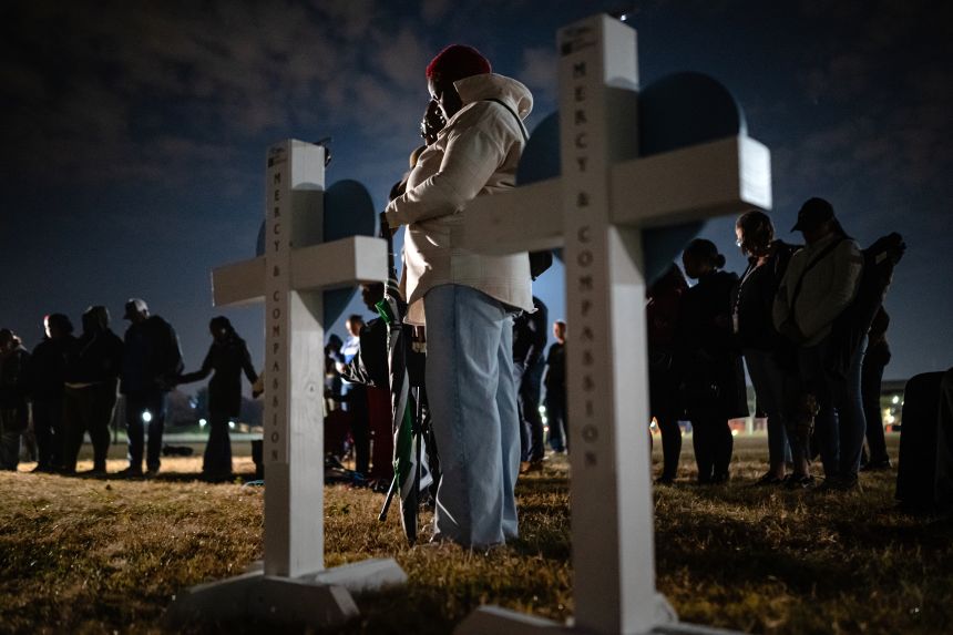 Community members embrace during a vigil for those killed and missing after a UPS plane crashed, at the Great Lawn in Louisville on Friday.