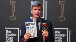 Hungarian-British author David Szalay poses for photographers with the trophy after winning the Booker Prize 2025 for his book 'Flesh' during a ceremony at Old Billingsgate in London, Monday, Nov. 10, 2025. (AP Photo/Kirsty Wigglesworth)