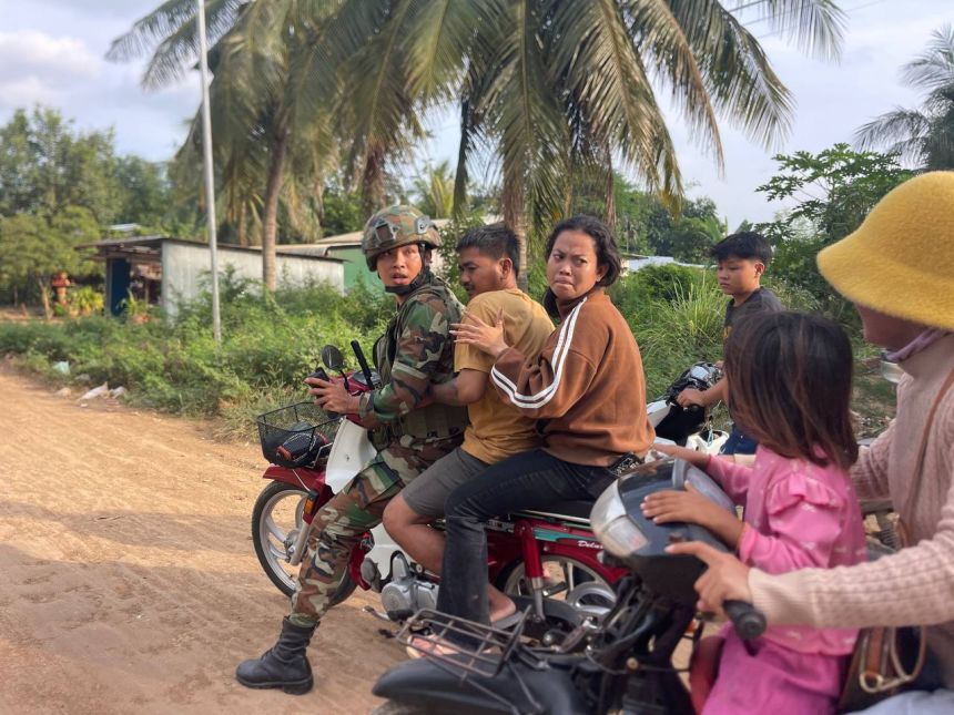 In this photo released by Agence Kampuchea Press (AKP), an injured man is picked up by a Cambodian army soldier on a motorbike after clashes between Thai and Cambodian troops, in Banteay Meanchey province, Cambodia, on November 12, 2025.