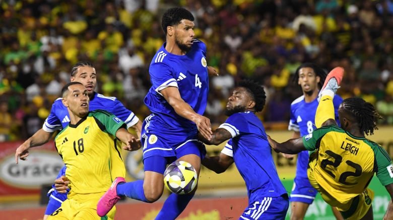 Curacao's Roshon Van Eijma, in the air, fights for the ball with Jamaica's Gregory Leigh, right, and Jonathan Russell during a World Cup 2026 qualifying soccer match in Kingston, Jamaica, on November 18, 2025.