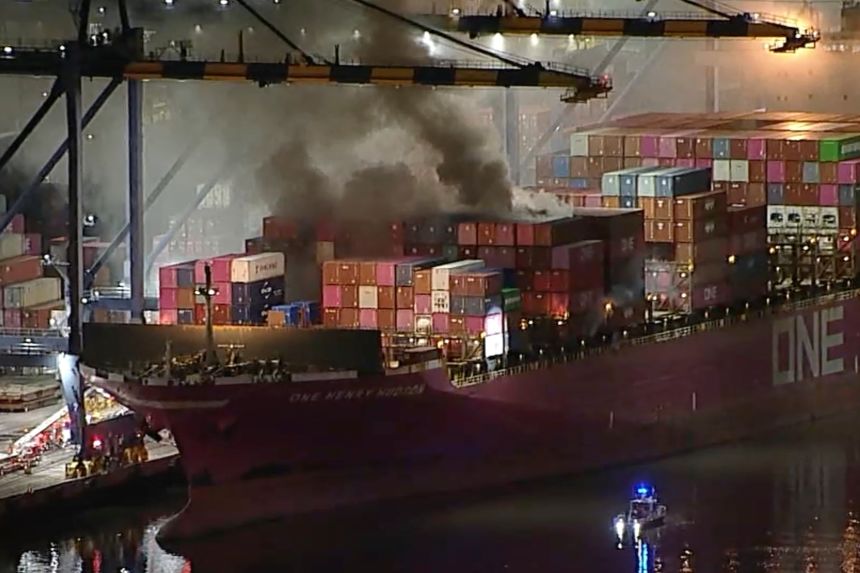 This image taken from video provided by ABC7 shows smoke rising from a blaze on a container ship docked at the Port of Los Angeles on Friday evening.