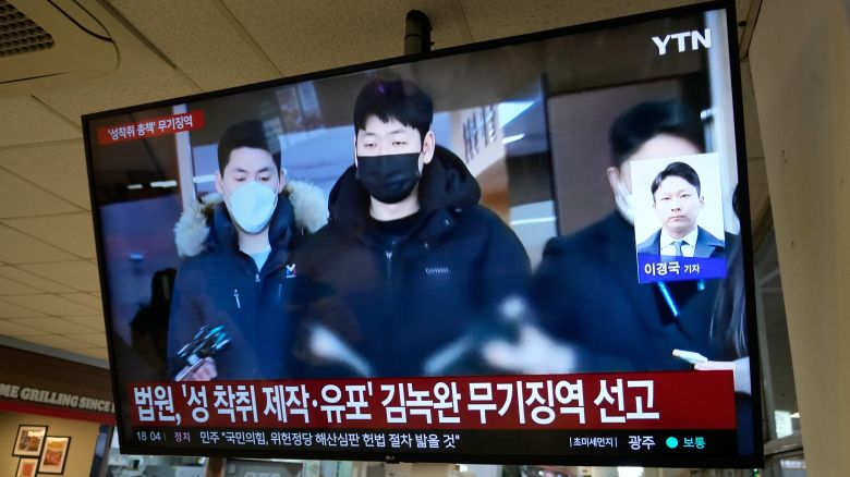 A TV screen shows a file image of Kim Nok-wan, center, the leader of a Telegram- based sex crime ring, during a news program at a express bus terminal in Seoul, South Korea, Monday, Nov. 24, 2025.