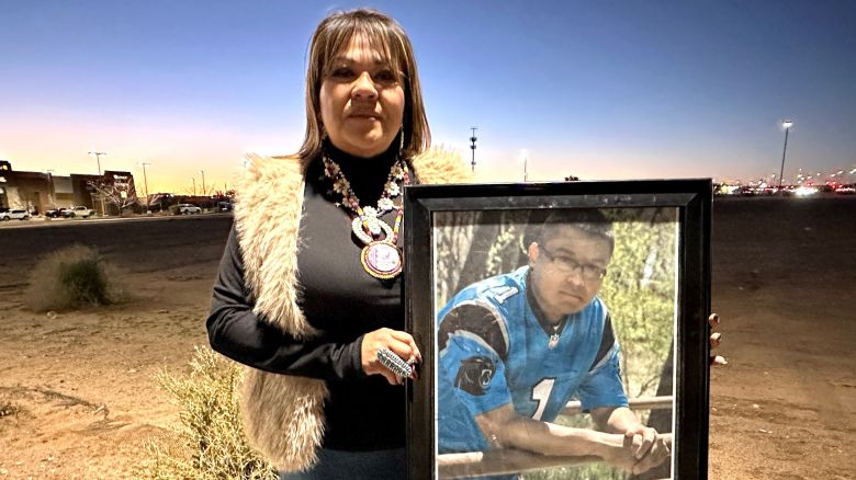 Vangie Randall-Shorty holds up a photograph of her son Zachariah Shorty during a stop in Bernalillo, New Mexico, on November 24, 2025.