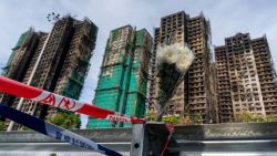 A bouquet of flowers near the buildings at the scene of where a major fire engulfed several residential buildings at Wang Fuk Court on November 28, 2025 in Hong Kong.