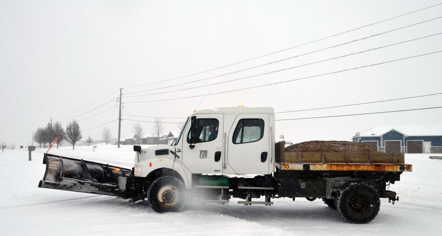 A snowplow driver from Sioux City, Iowa, clears roads Saturday.