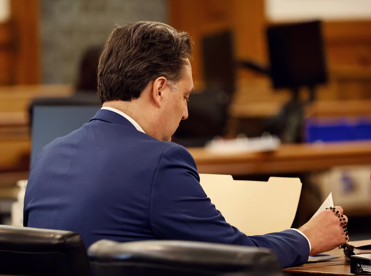 Brian Walshe looks over court papers in Norfolk Superior Court on Monday.