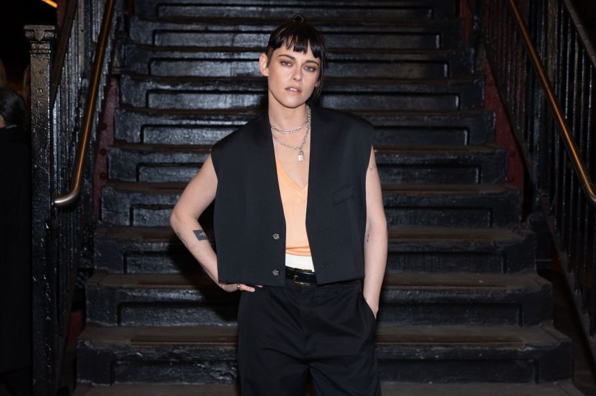 Kristen Stewart, a Chanel brand ambassador, attended the show in a vest over layered tank tops and black trousers.