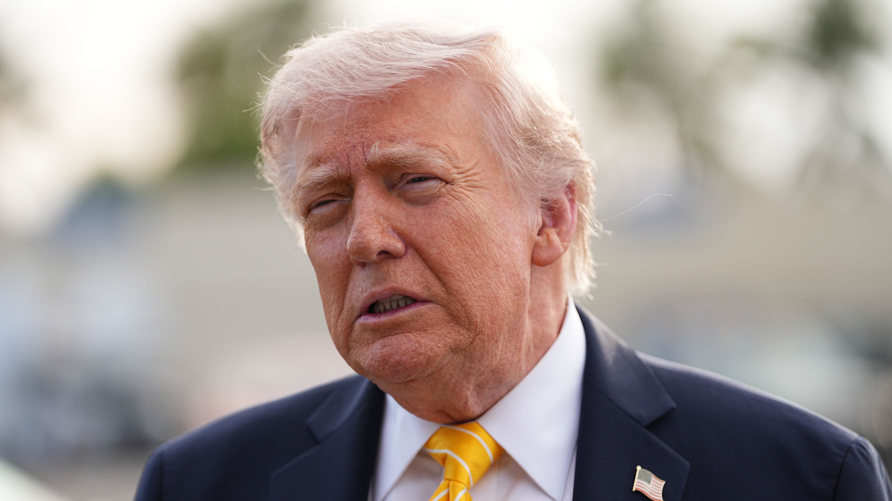 President Donald Trump talks to reporters before he boards Air Force One at Palm Beach International Airport in West Palm Beach, Florida, on Saturday.