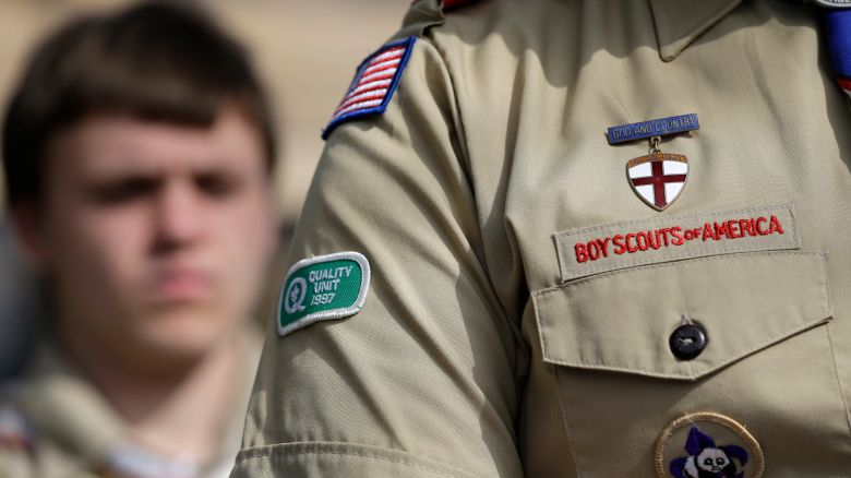 The Boy Scouts uniform fashioned with an Quality patch is on the arm of Brad Hankins, a campaign director for Scouts for Equality, as he responds to questions during a news conference in front of the Boy Scouts of America headquarters Monday, Feb. 4, 2013, in Dallas, Texas. Scouts and their families have delivered a petition to the Boy Scouts of America headquarters urging an end to a policy banning gay scouts and leaders from the organization. (AP Photo/Tony Gutierrez)