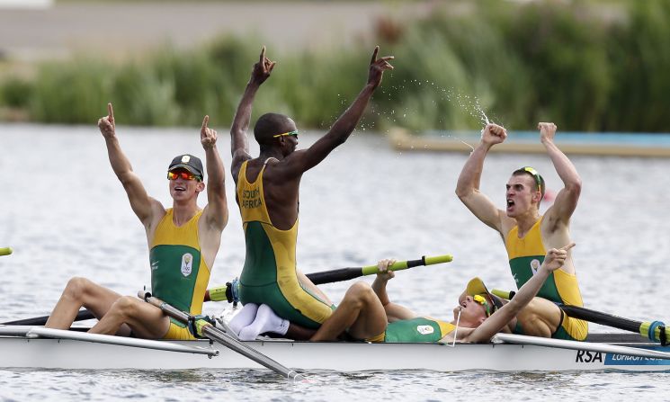 From left, <strong>Sizwe Ndlovu, John Smith, Matthew Brittain and James Thompson</strong> celebrate after winning the gold medal for the lightweight men's rowing four at the 2012 Summer Olympics.