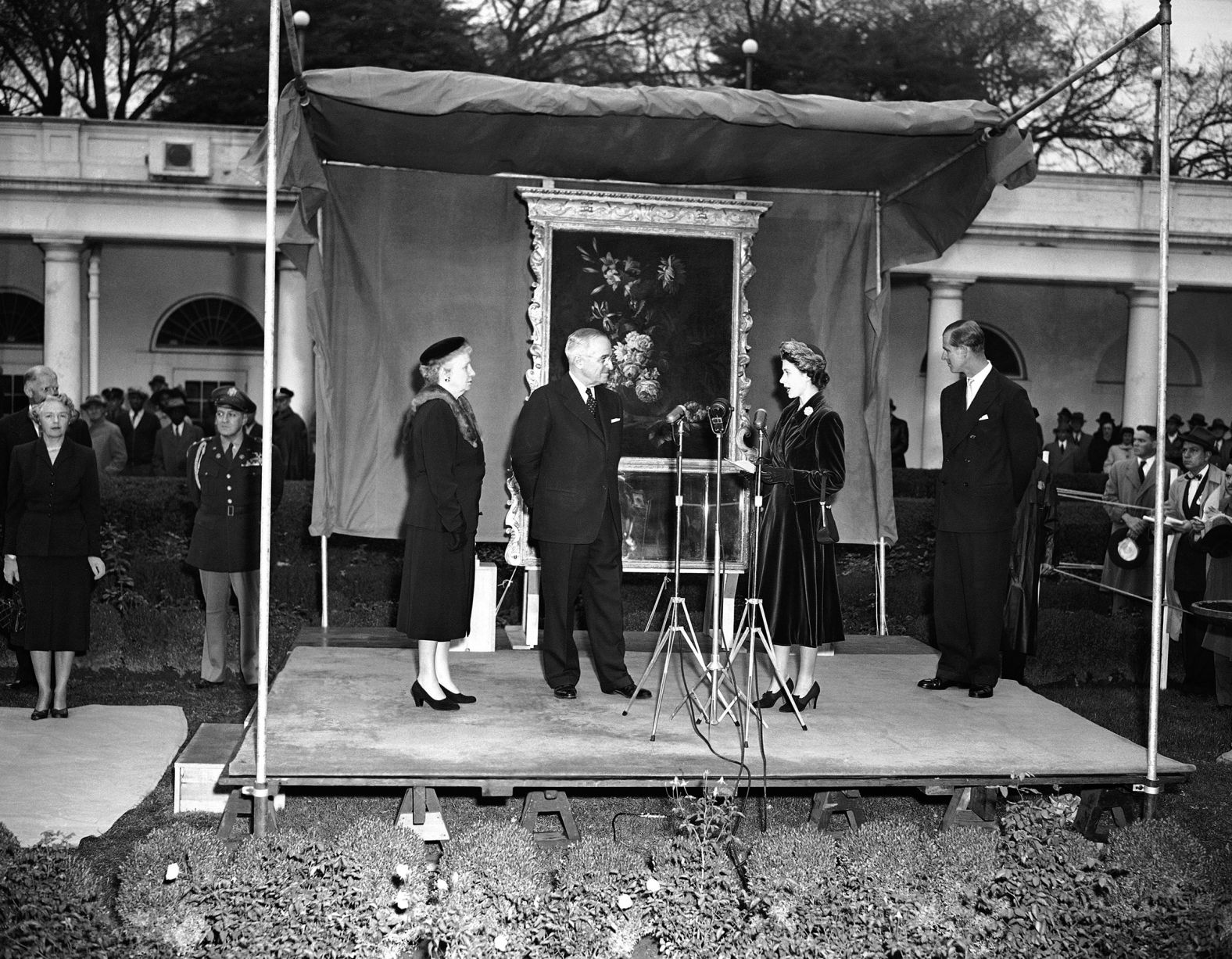 Princess Elizabeth presents to President Harry Truman a looking glass (background) for the renovated White House. Mrs. Bess Truman is at left in the White House Rose garden ceremony on Nov. 2, 1951 in Washington. The Princess also gave the President a pair of candelabra. The gifts are from her father king George VI. (AP Photo)