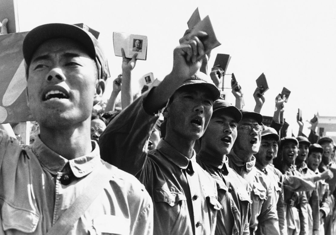 Red Guards hold aloft booklets containing the writings of Mao Zedong as they lead a demonstration of some 200,000 people in front of the Soviet Embassy in Beijing on August 29, 1966.