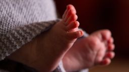 Born babies stats. File photo dated 23/01/16 of the feet of a new baby wrapped in a blanket.