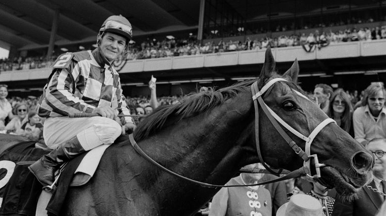 Jockey Ron Turcotte walks Secretariat towards the winners circle after they captured the Triple Crown for 1973 by winning the Belmont Stakes at Belmont Park, N.Y., June 9, 1973, before a crowd of 70,000 fans.  (AP Photo)