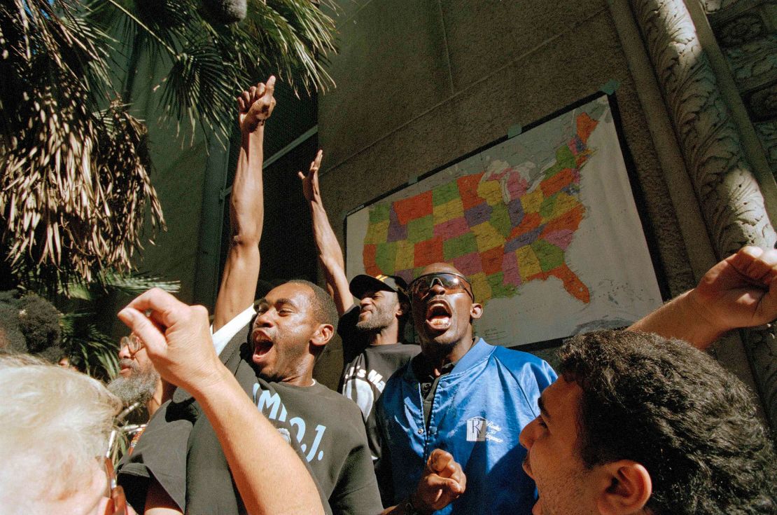 Supporters of O.J. Simpson react outside the Criminal Courts Building to the not guilty verdict in Simpson's murder trial on October 3, 1995, in Los Angeles.